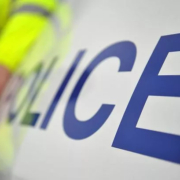 A general stock image of a police car and officer
